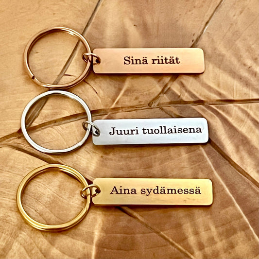 Nimikoitu avaimenperä, ruostumatonta terästä